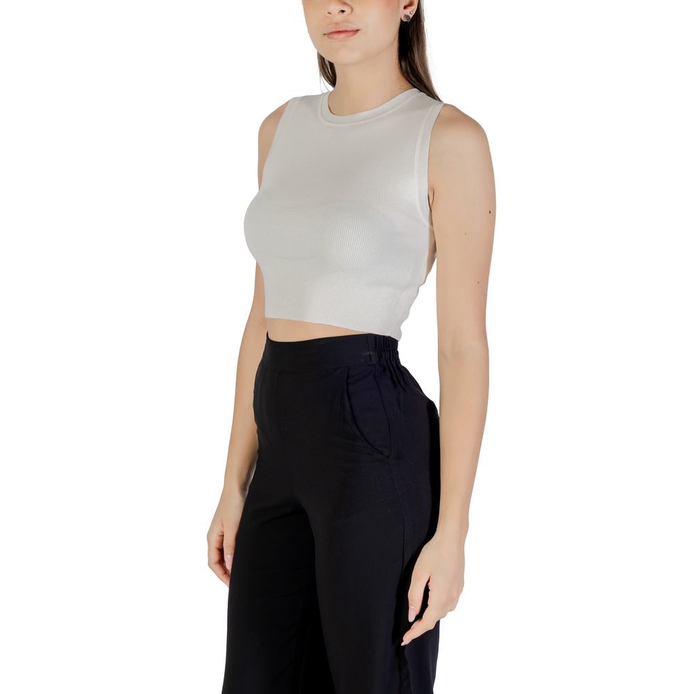 Jacqueline De Yong White Viscose Tank Tops worn by model, showcasing sleeveless cropped design with high-waisted black pants.
