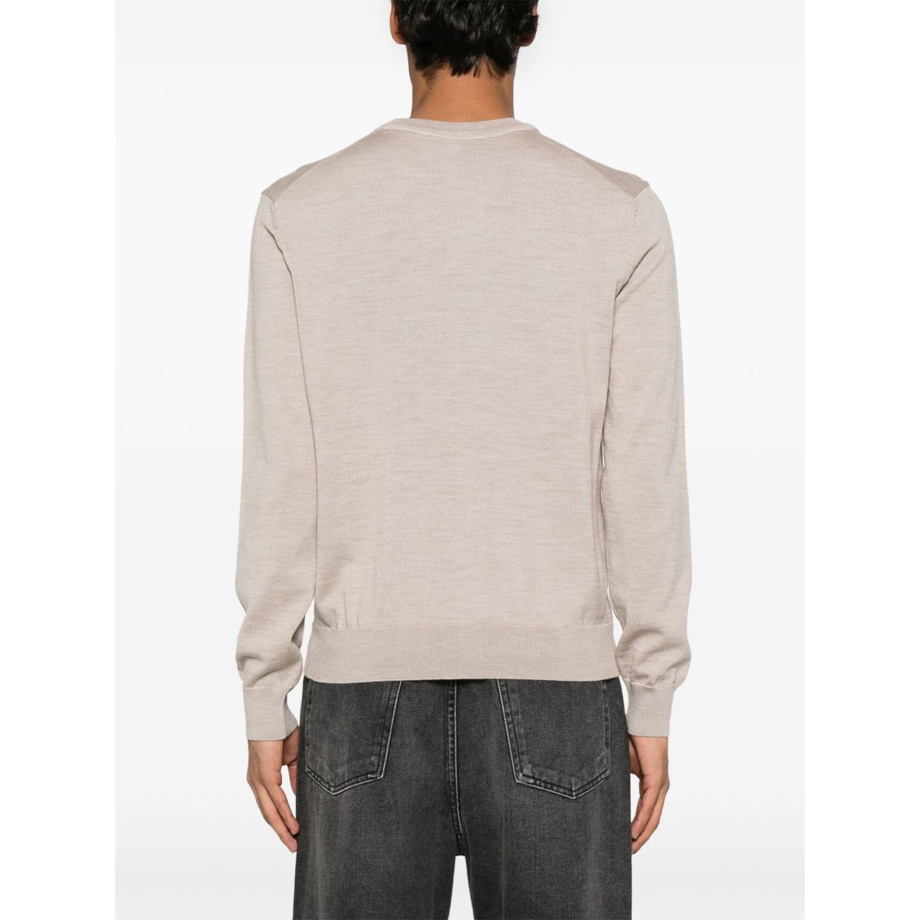 Back view of model wearing Maison Kitsuné Maison Kitsune Fox motif sweater in light beige with crew neck and ribbed cuffs.