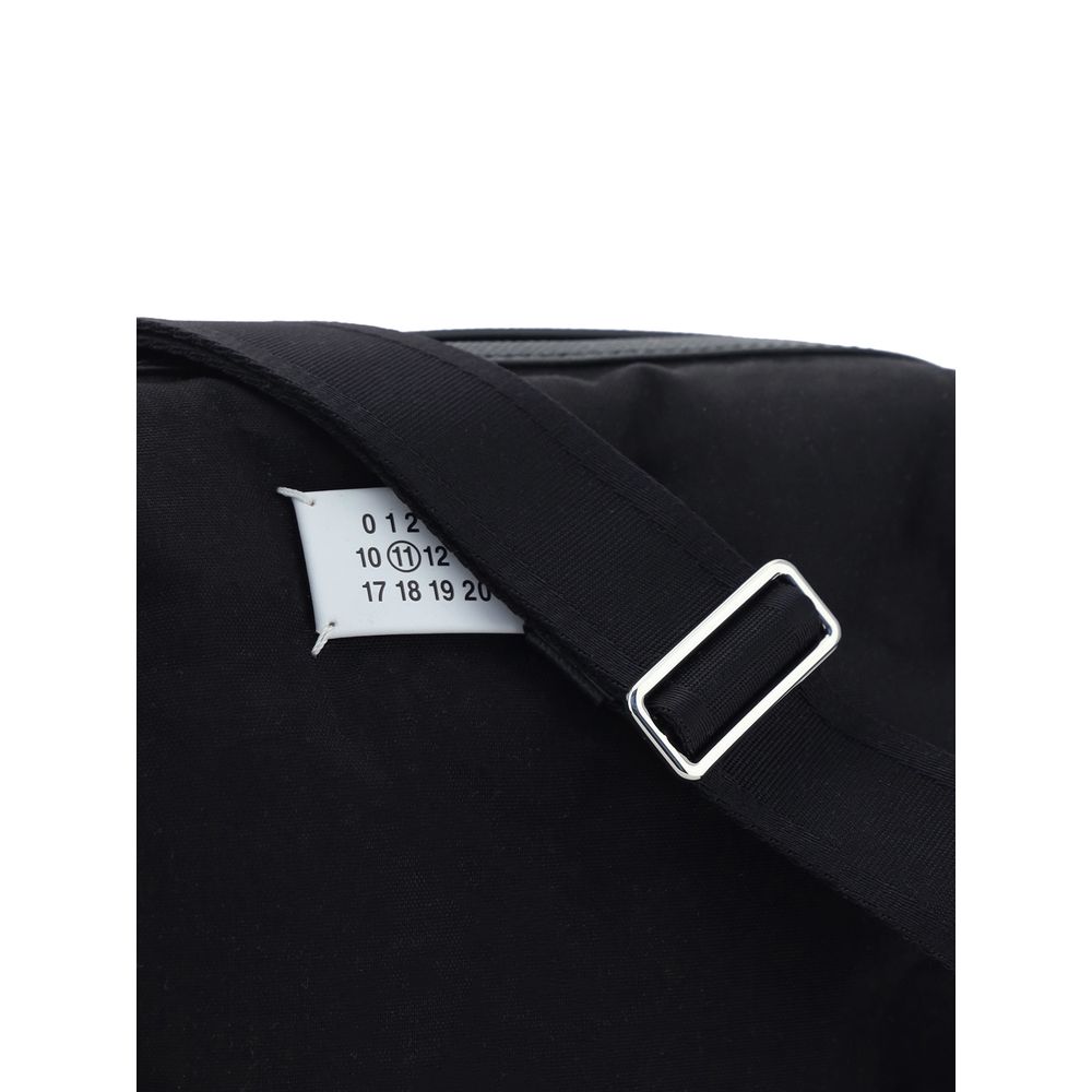 Close-up of Margiela Black Nylon Shoulder Bag with adjustable strap and logo label detail.