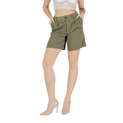 Model wearing Only Green Viscose Bermuda Shorts with side pockets and button closure, ideal for warm days.