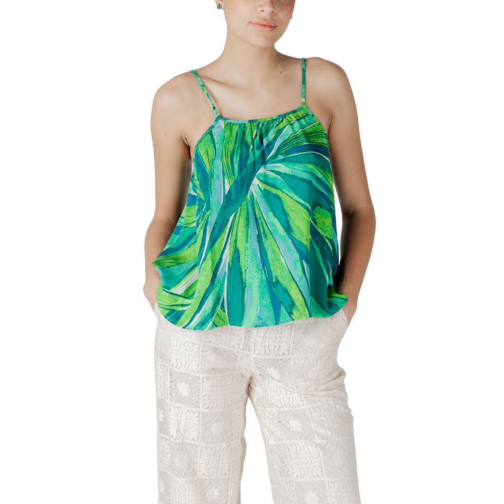 Woman wearing Only Green Viscose Tank Top with floral pattern and white pants, stylish spring summer fashion.