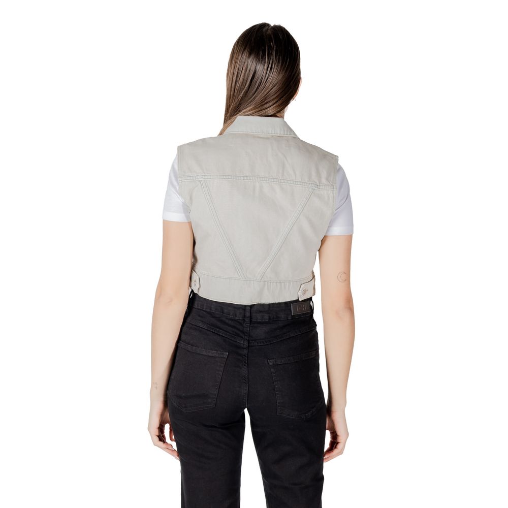 Back view of Only Light Blue Cotton Sleeveless Jacket worn over a white t-shirt, showcasing cropped fit and denim detail.