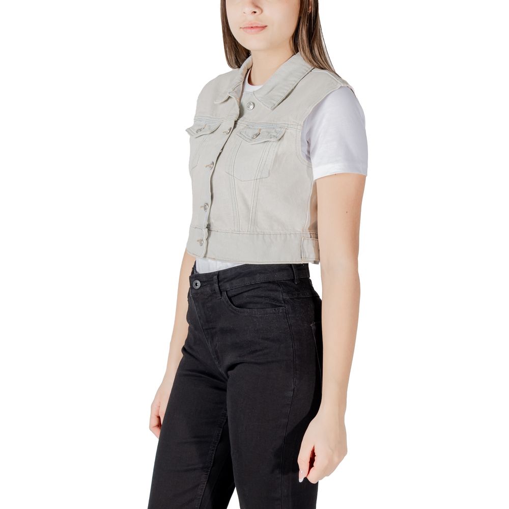 Only Light Blue Cotton Sleveless Jacket with metallic buttons and pockets styled over a t-shirt, shown in a side view.