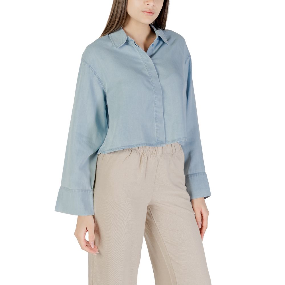 Woman wearing Only Light Blue Lyocell Blouse with long sleeves and cropped cut.