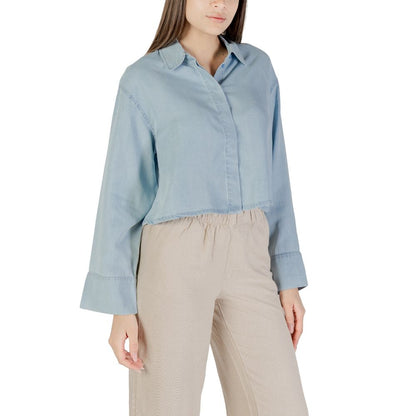 Woman wearing Only Light Blue Lyocell Blouse with long sleeves and cropped cut.