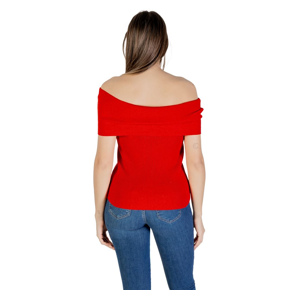 Woman wearing Only Red Polyester T-Shirt, off-shoulder design, paired with jeans, showcasing sustainable fashion.