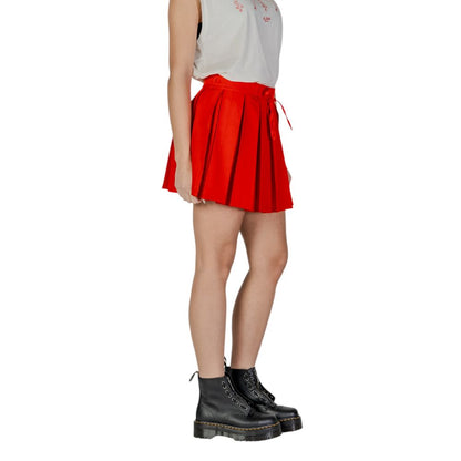 Only Red Recycled Polyester Mini Skirt with pleated flared design and adjustable drawstring waistband, paired with black boots.