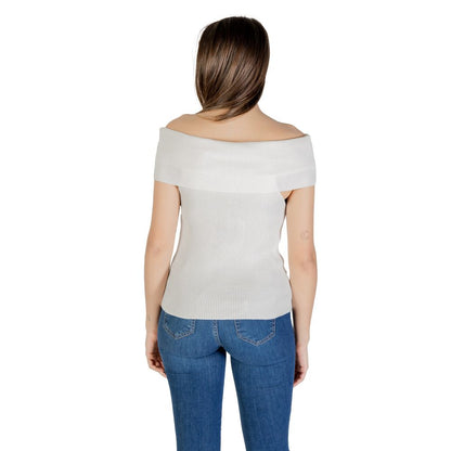 Woman wearing Only White Polyester T-Shirt, off-shoulder white top with short sleeves, paired with jeans, back view