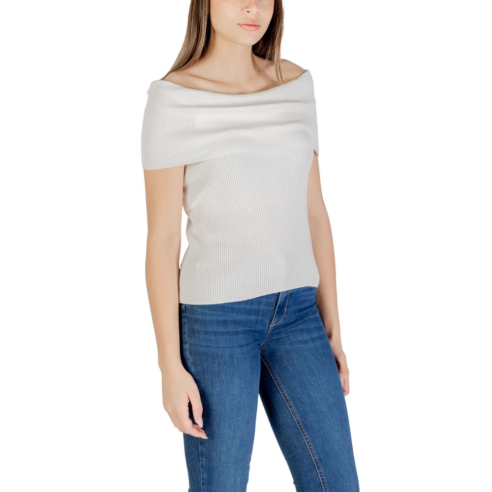 Woman wearing Only White Polyester T-Shirt with off-shoulder design, paired with jeans, showcasing stylish and sustainable fashion.