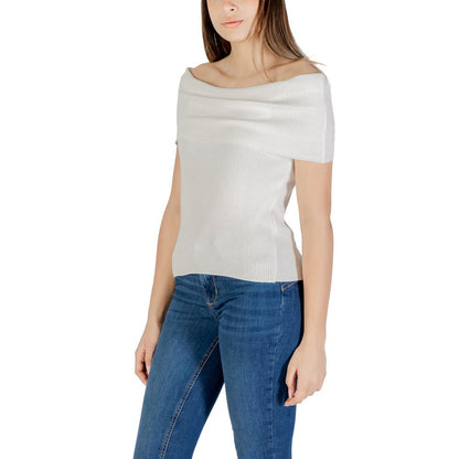 Woman wearing Only White Polyester T-Shirt with off-shoulder design, paired with jeans, showcasing elegance and sustainability.