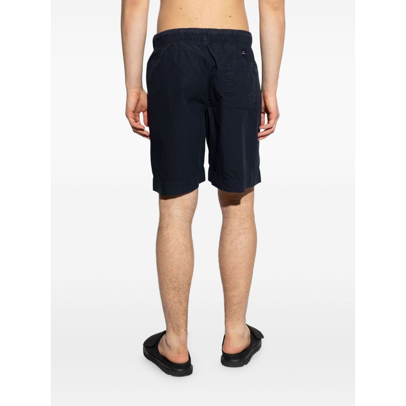 Back view of model wearing Paul Smith Shorts Blue, navy cotton knee-length with drawstring waistband, side pockets.