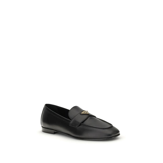 Prada Leather Loafers with flat sole and logoed plaque, crafted from smooth calf leather, showcasing classic elegance and contemporary style.
