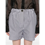 Model wearing SportMax Shorts Black with stripe design, button and zip fastening, elastic waist, side slash pockets, and rear patch pockets.