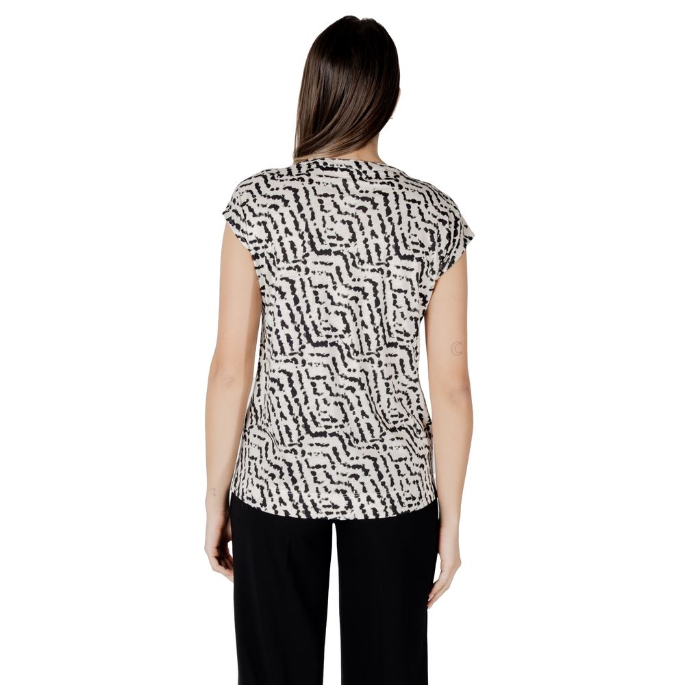 Back view of Street One Cream Cotton T-Shirt with unique print, perfect for a casual-chic look, paired with black trousers.