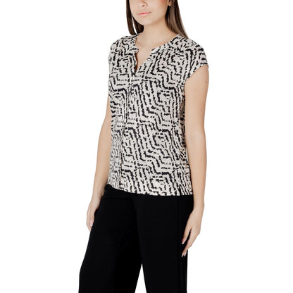 Woman wearing Street One Cream Cotton T-Shirt with unique print, short sleeves, and button panel, paired with black trousers for a chic look.