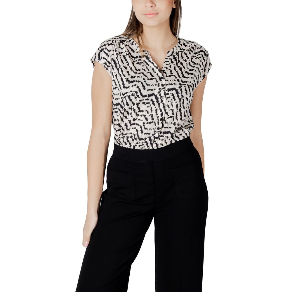 Woman wearing Street One Cream Cotton T-Shirt with unique print and button panel, paired with black trousers for a casual-chic look.