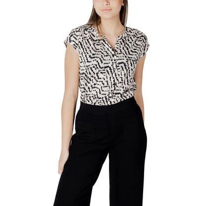 Woman wearing Street One Cream Cotton T-Shirt with unique print and button panel, paired with black trousers for a casual-chic look.