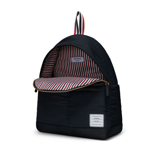 Thom Browne Multipocket backpack in black with logo, two-way zip, front and side pockets, and striped lining.