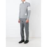 Model wearing Thom Browne Sweaters Grey with 4-Bar stripe, loopback cotton jersey, V insert neckline, and ribbed trims.