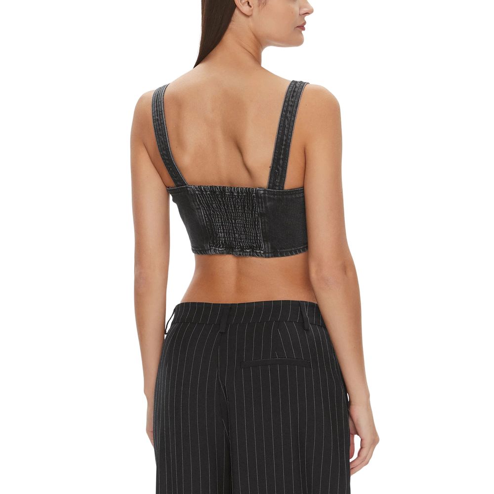 Back view of woman wearing Tommy Hilfiger Jeans Black Recycled Cotton Top with pinstripe pants.