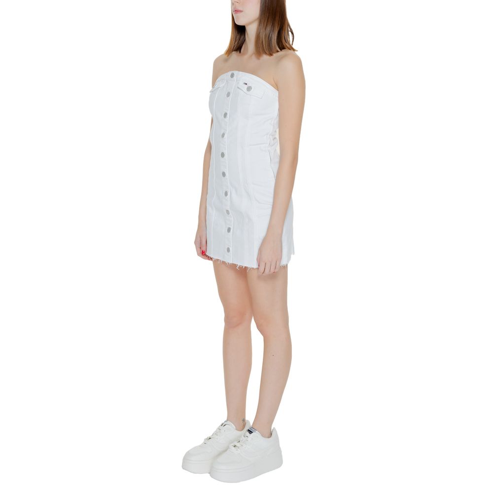 Model wearing Tommy Hilfiger Jeans White Recycled Cotton Short Dress with strapless bustier design and metallic buttons.