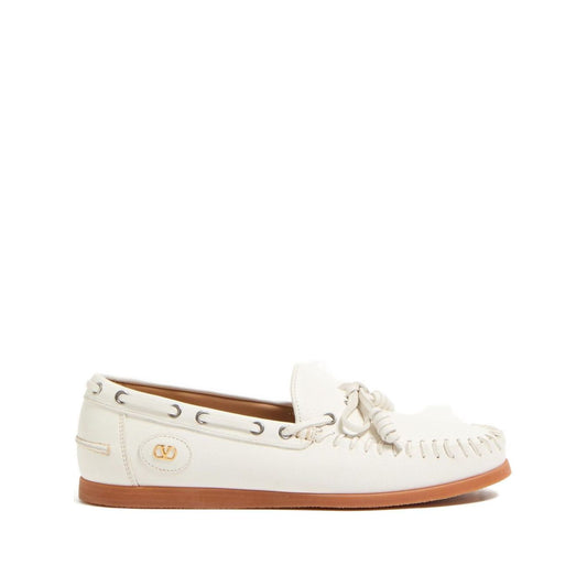 Valentino Garavani Palm Avenue Buffalo Boat Shoe with white leather and VLogo Signature bow detailing, flat rubber sole.