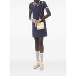 Valentino Short Embroidered Crepe Couture Dress in navy blue with rhinestone embellishments, modeled with gloves and handbag.
