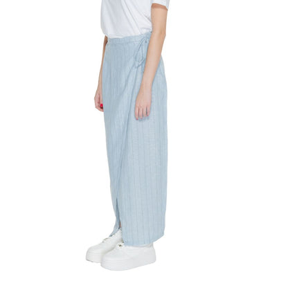 Vero Moda Light Blue Linen Long Skirt with wrap design and side tie, paired with white sneakers, ideal for spring fashion.