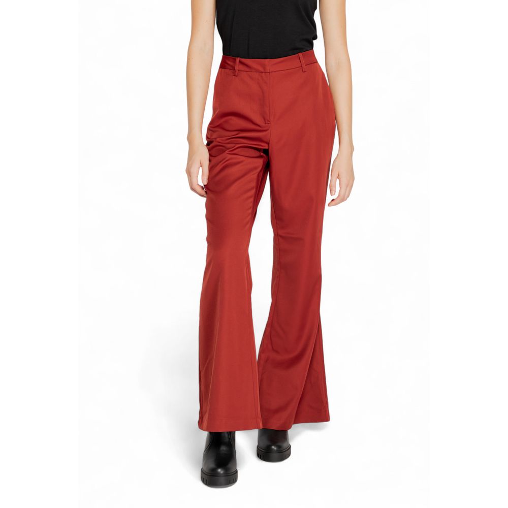 Woman wearing Vero Moda Red Polyester Flared Pants with mid-rise waist and wide leg cut.
