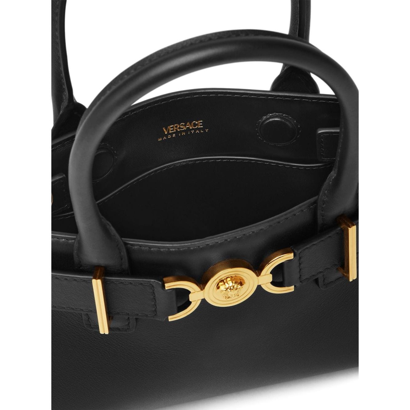 Close-up of Versace Medusa '95 leather tote bag featuring black leather with gold-tone Medusa hardware, interior view.