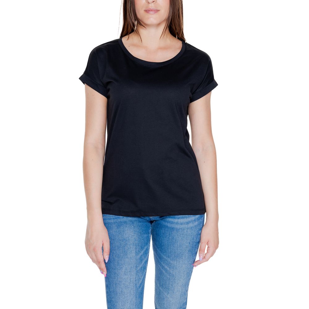 Woman wearing Vila Clothes Black Cotton T-Shirt with rolled-up sleeves, round neckline, and blue jeans. Casual style.