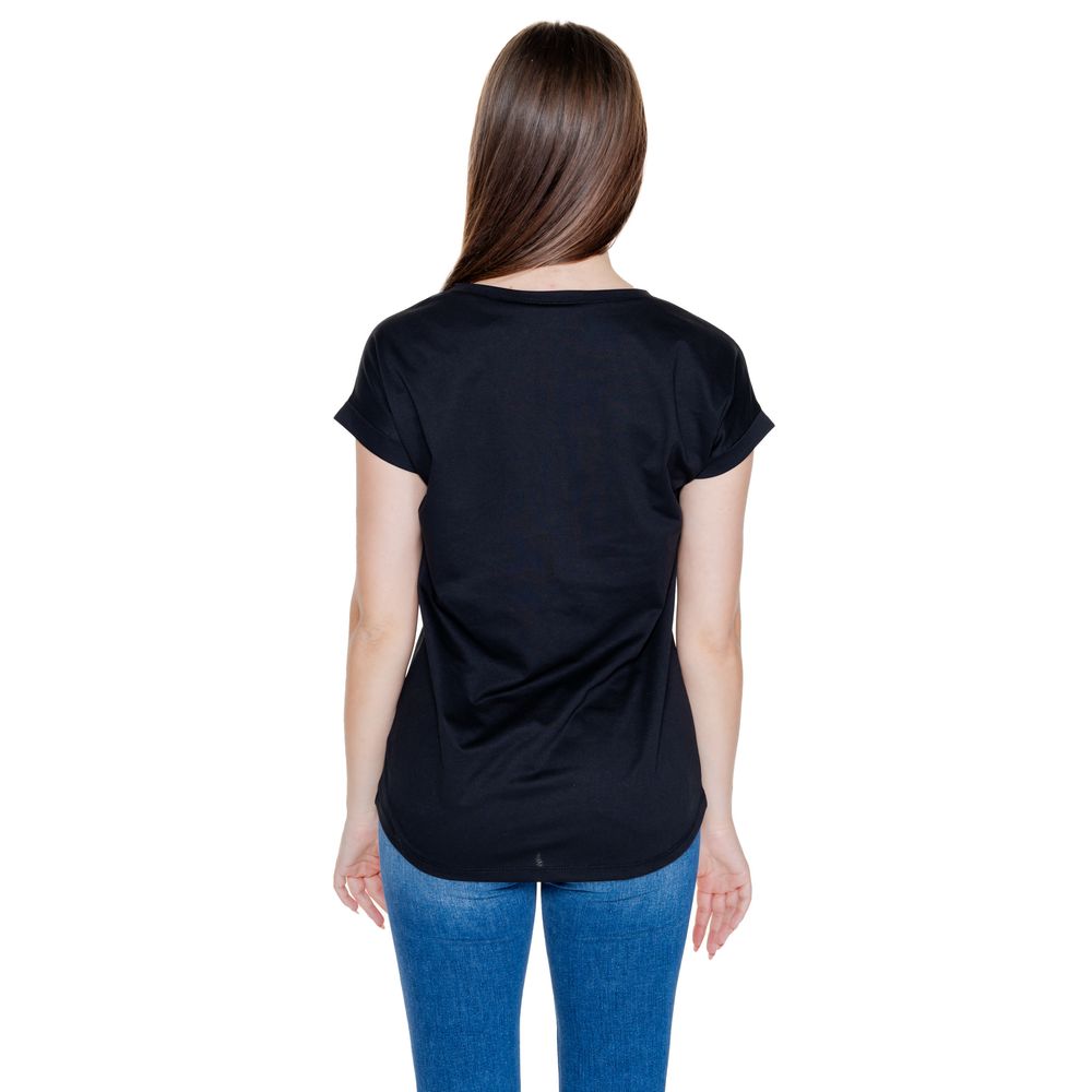 Back view of woman wearing Vila Clothes Black Cotton T-Shirt with rolled-up sleeves and round neckline, showcasing casual style and comfort.