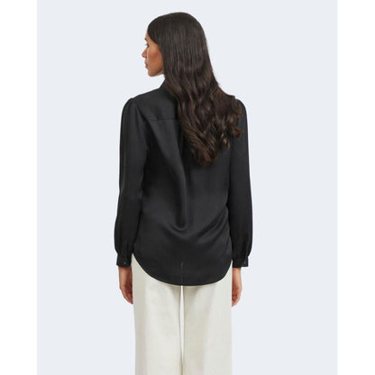 Woman wearing Vila Clothes Black Polyester Blouse with satin texture and long sleeves, viewed from the back.
