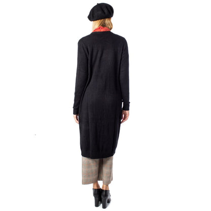 Back view of a woman wearing a Vila Clothes Black Viscose Cardigan with a beret and check pants, standing against a white background.