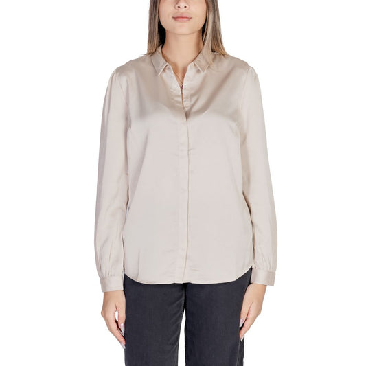 Woman wearing Vila Clothes Gold Polyester Blouse with long sleeves and satin texture; essential addition to any wardrobe.