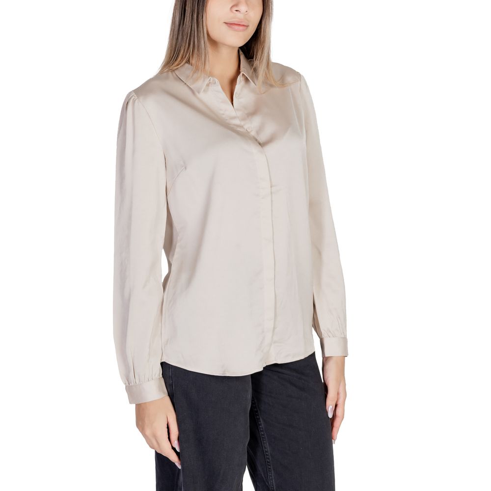 Woman wearing Vila Clothes Gold Polyester Blouse with long sleeves and satin texture, perfect for versatile wardrobe options.