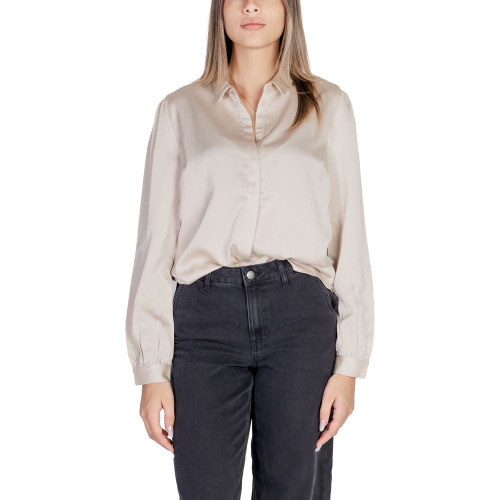 Woman wearing Vila Clothes Gold Polyester Blouse with satin finish and long sleeves for elegant occasions.