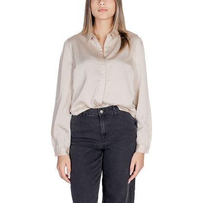 Woman wearing Vila Clothes Gold Polyester Blouse with satin finish and long sleeves for elegant occasions.