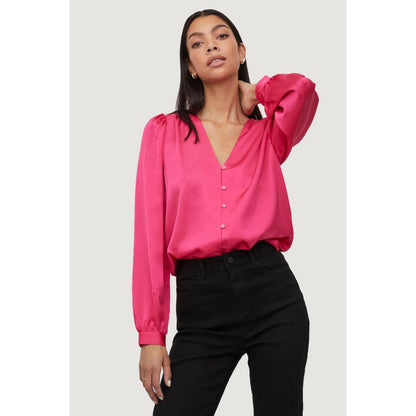Model wearing Vila Clothes Pink Polyester Blouse with V-neck and long sleeves, highlighting its elegant and versatile style.